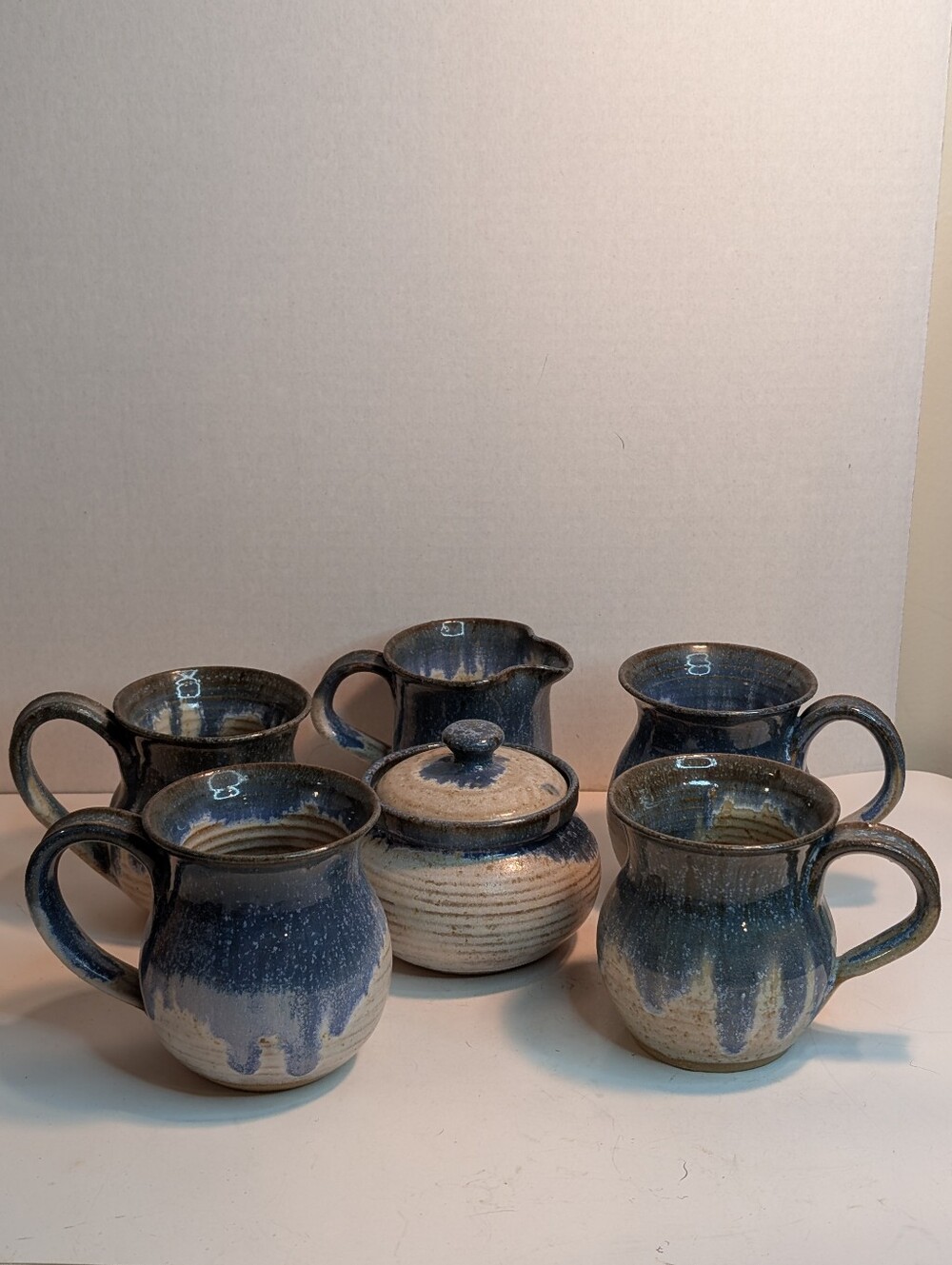 A matching ceramic pottery coffee set featuring cobalt blue and tan Pottery.